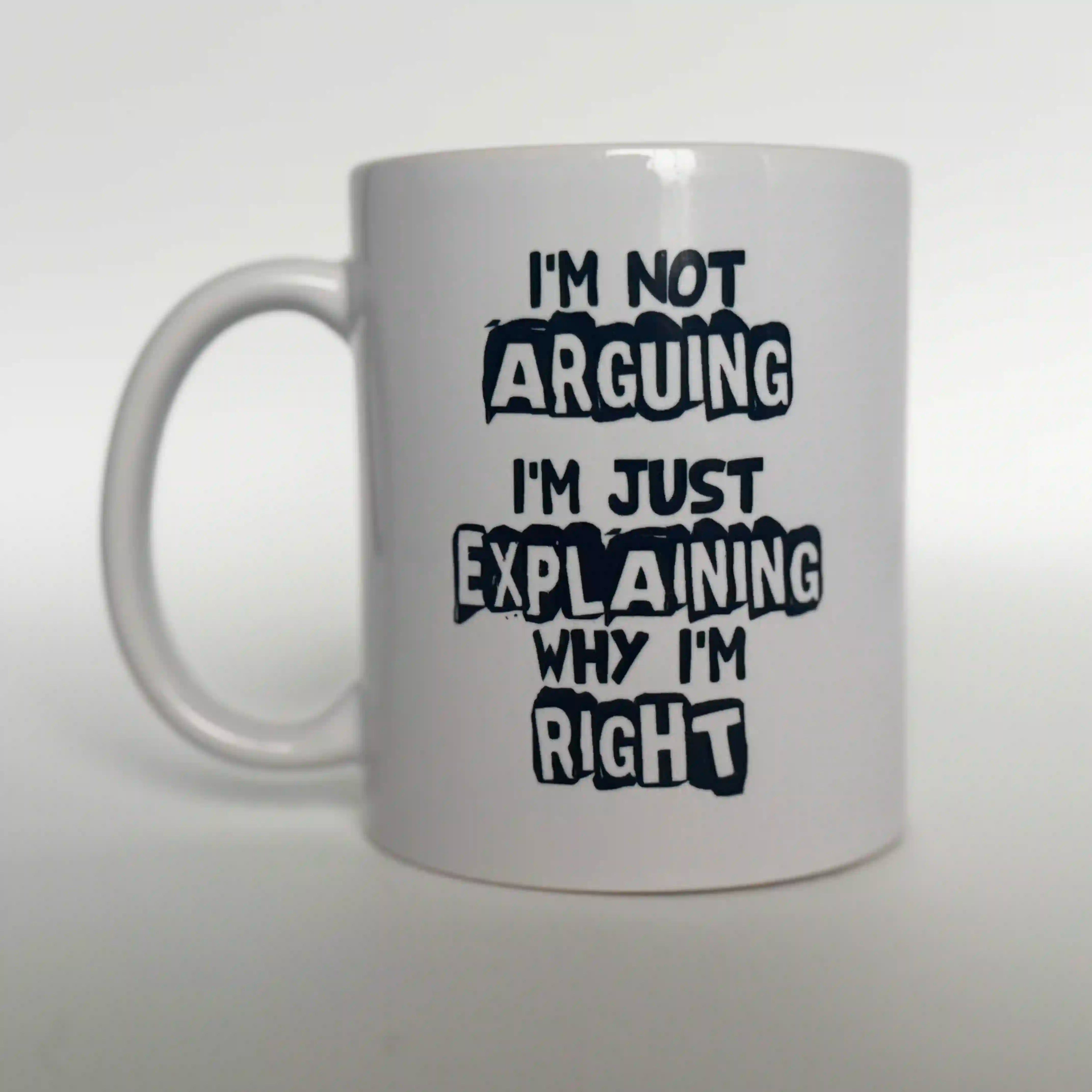Black text on a white ceramic mug that reads: "I'm Not Arguing I'm Just Explaining Why I'm Right." Funny quote mug for lawyers, debates, or sarcastic coworker gifts.