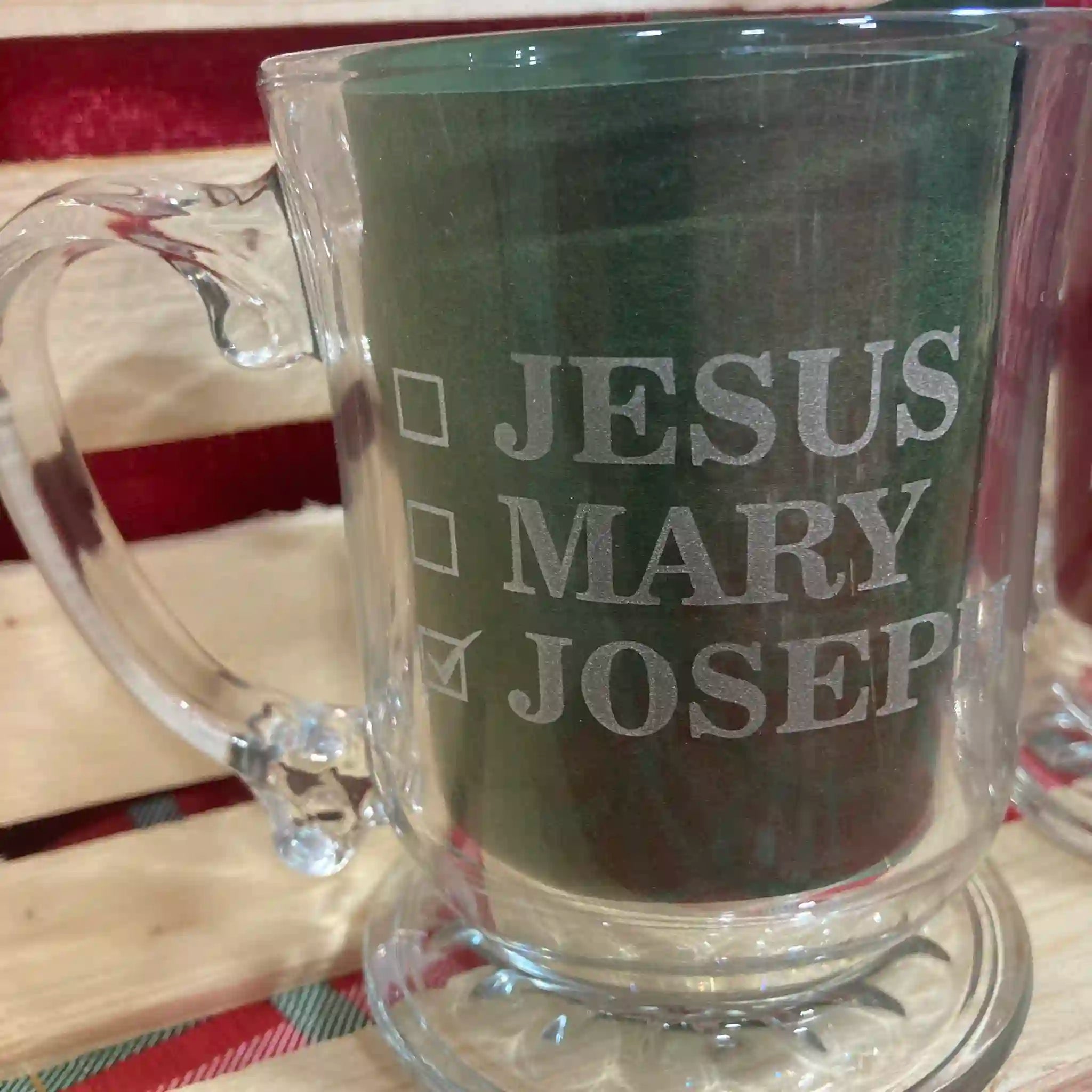 Clear glass mug with text 'JESUS MARY JOSEPH' Checkboxes next to the names, to mean that is the name of the mug owner. JOSEPH is checked.