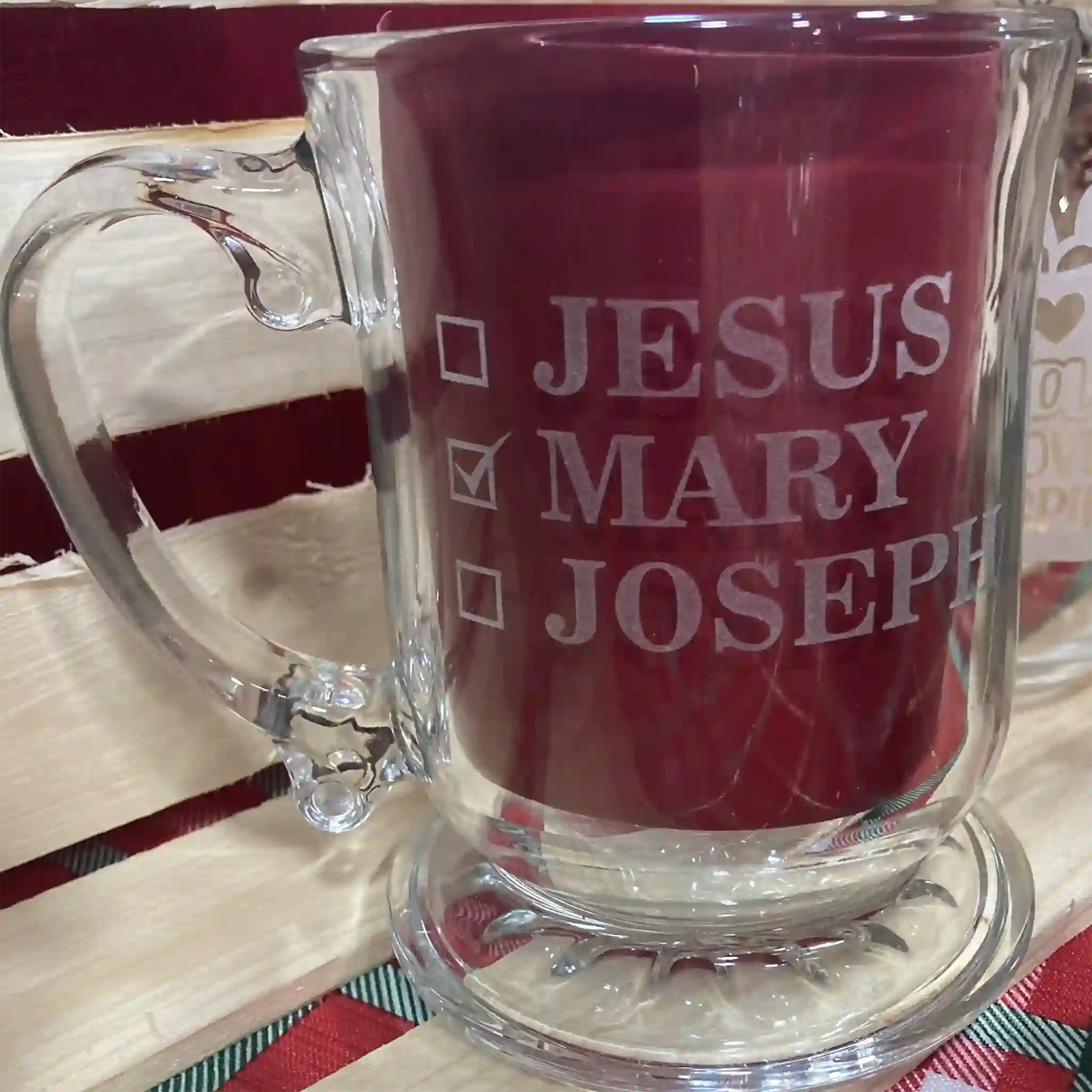 Clear glass mug with text 'JESUS MARY JOSEPH' Checkboxes next to the names, to mean that is the name of the mug owner. MARY is checked.