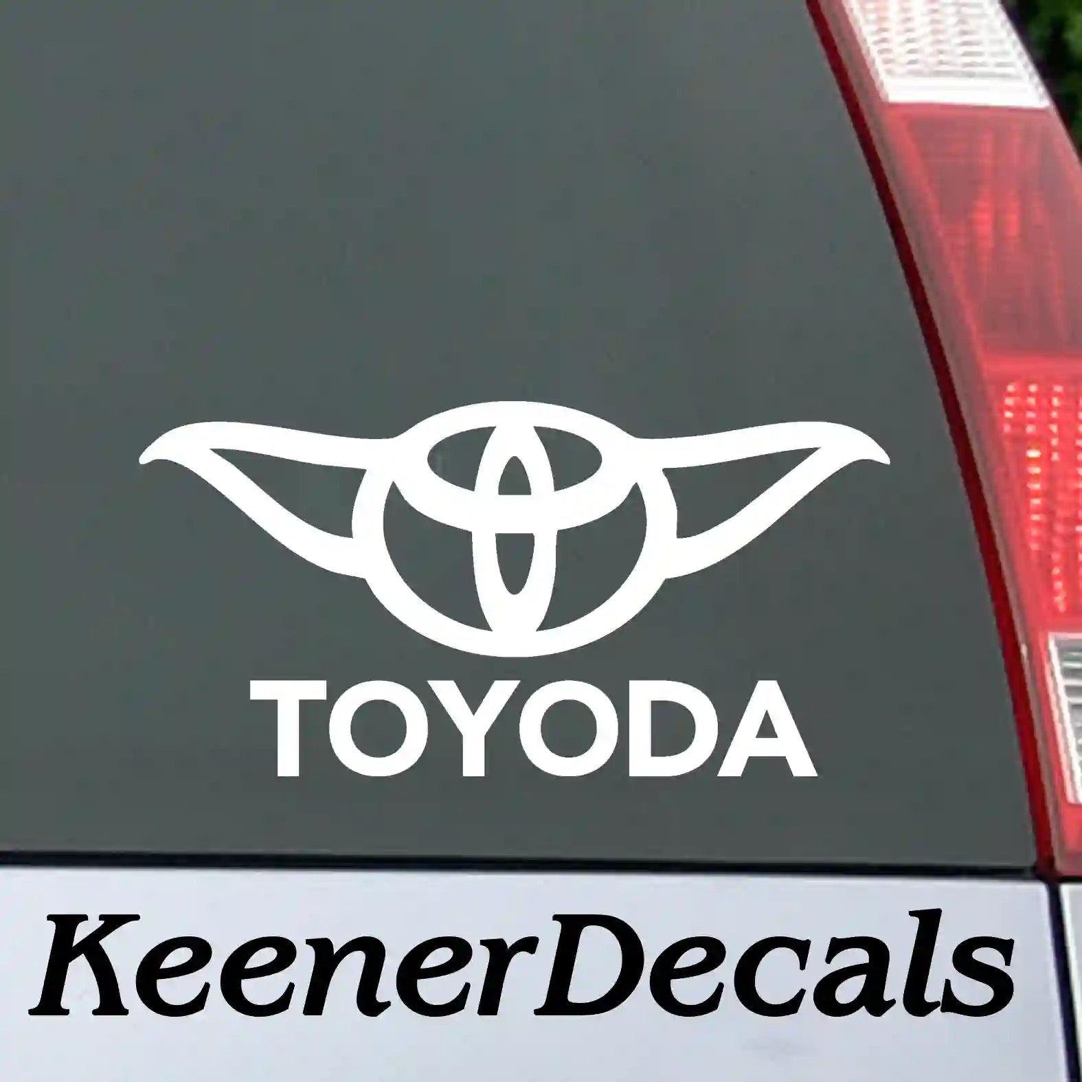 White vinyl decal featuring a mashup of a classic 4x4 logo with science fiction ears and the text "Toyoda" in a stylized font.