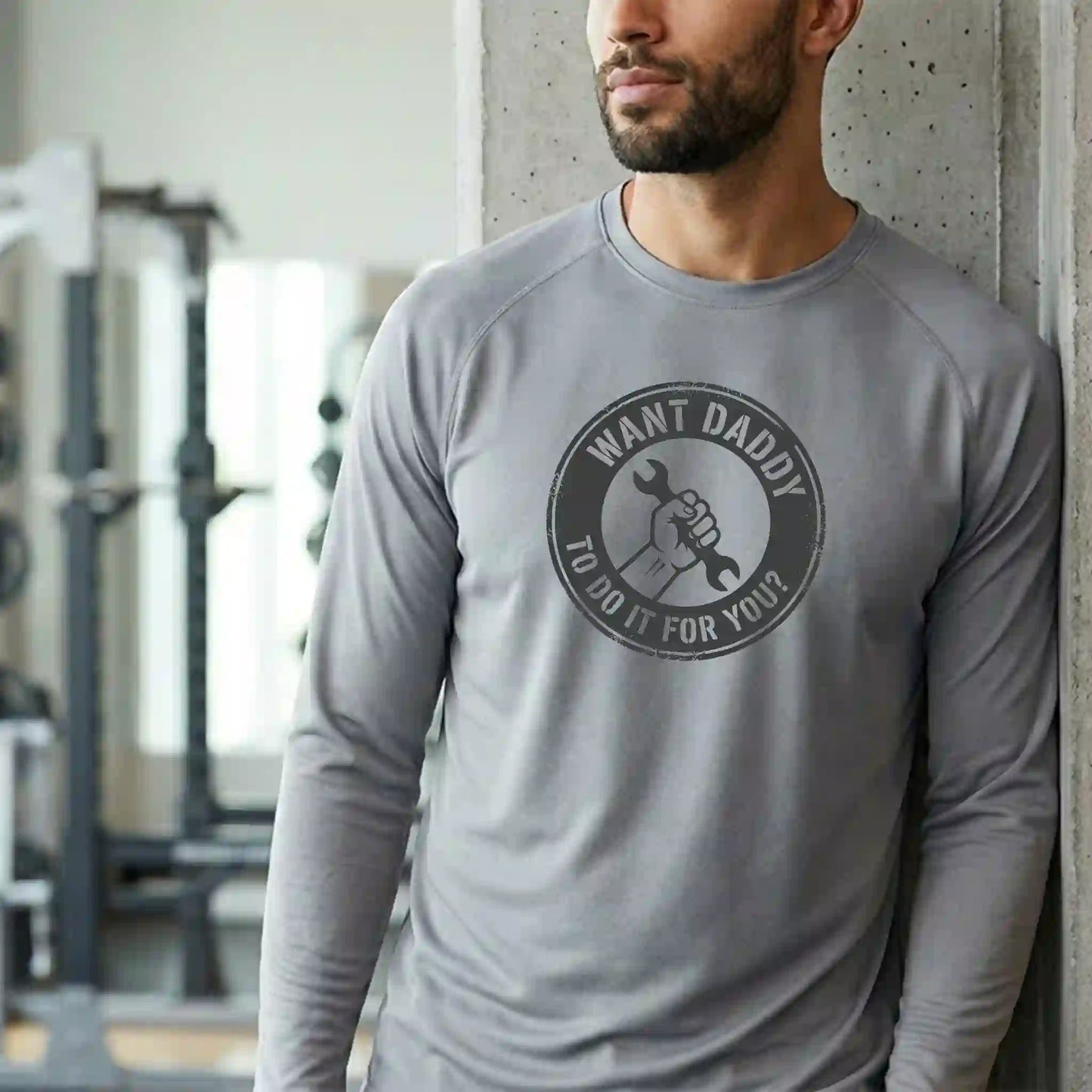 Male model wearing a long-sleeve version of the 'Want Daddy To Do It?' moisture-wicking shirt - Professional grade trade apparel by Keener Gifts.