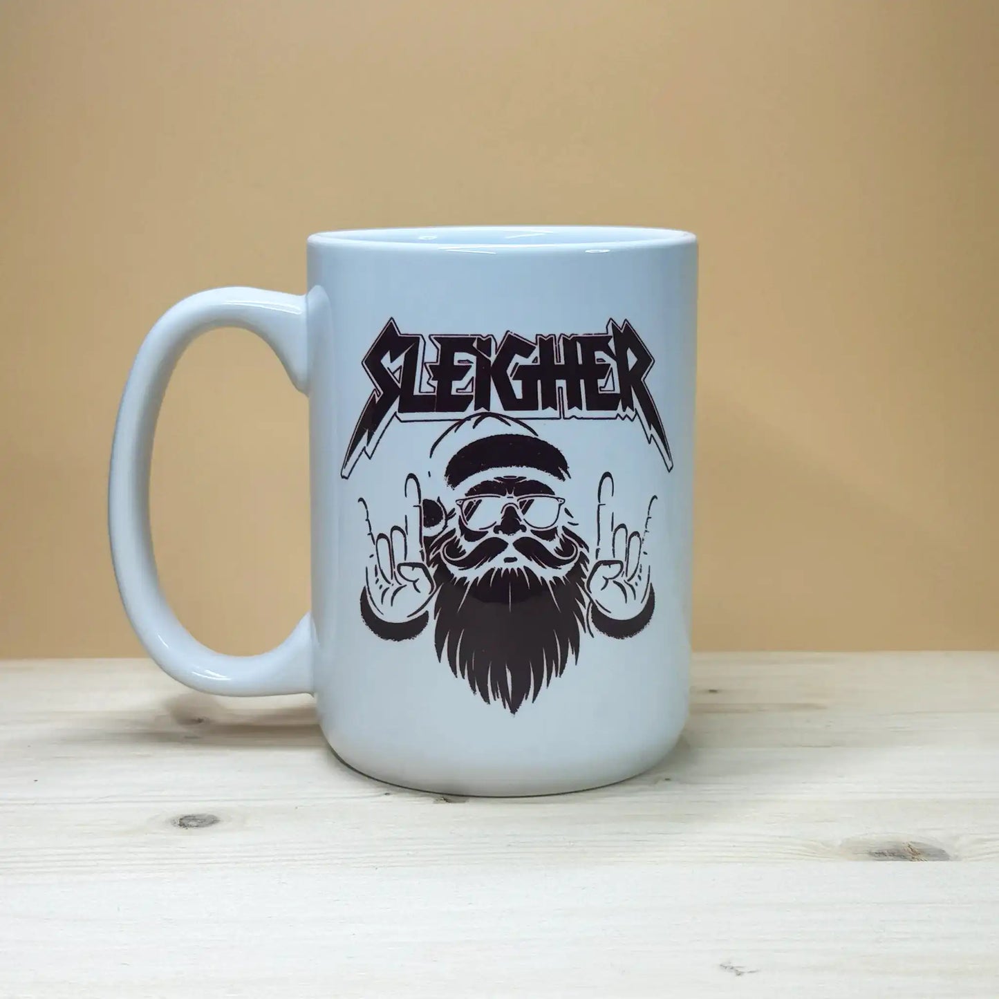 Rock and roll Christmas 15oz coffee cup featuring a thrash metal style holiday design.