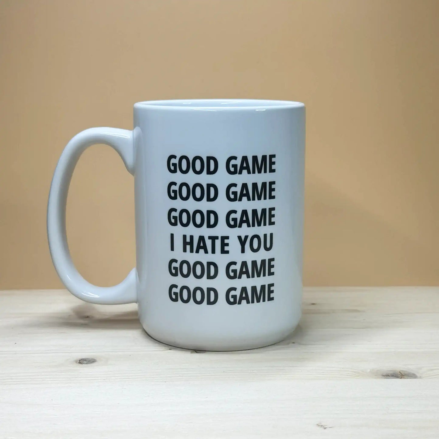 Funny volleyball coach gift idea 15oz coffee cup with sarcastic handshake quote on a rustic pine base.