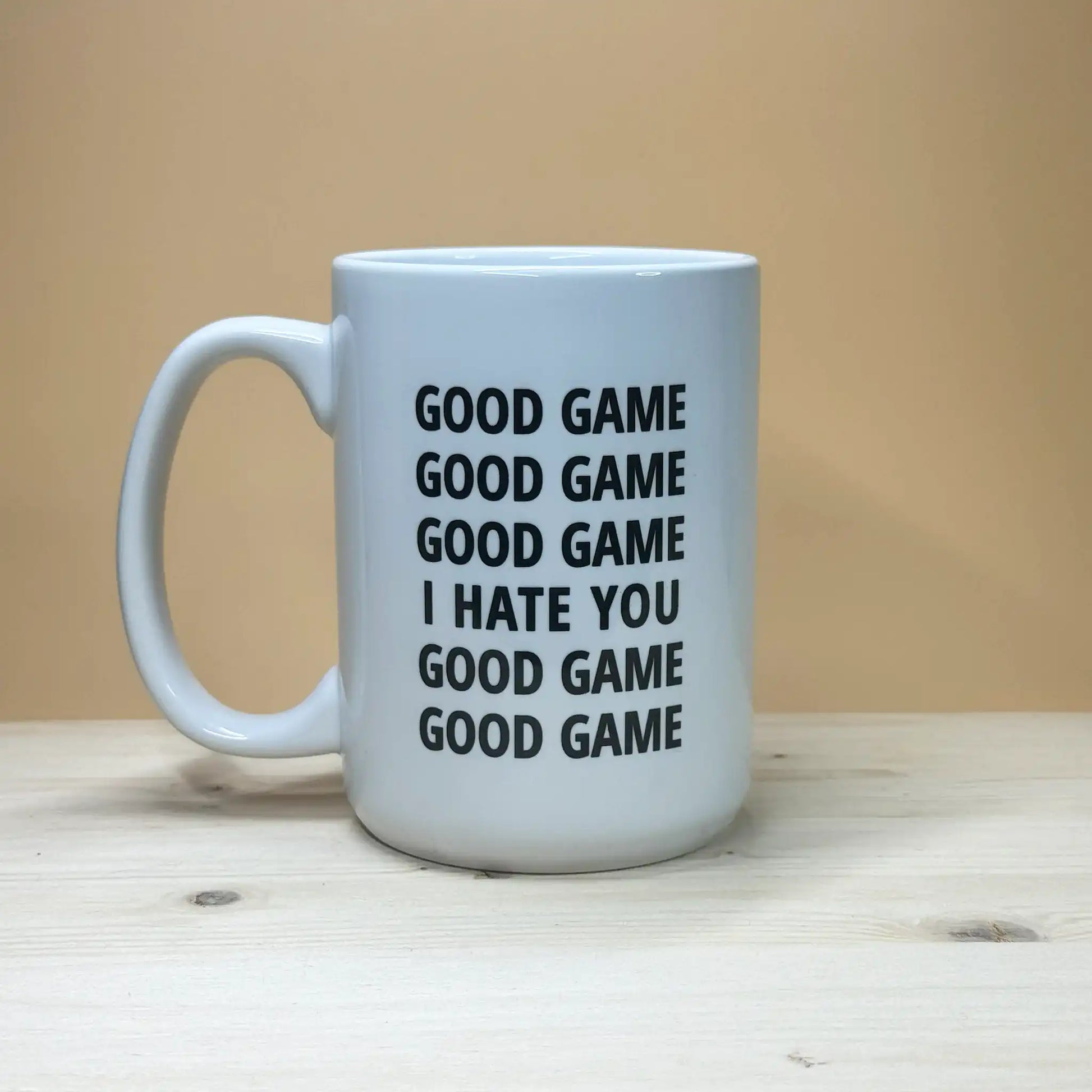 Funny volleyball coach gift idea 15oz coffee cup with sarcastic handshake quote on a rustic pine base.